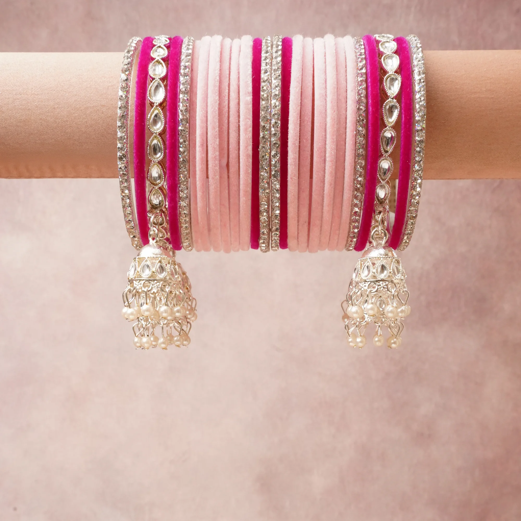 A commanding Pale Pink anchors this beautiful set, enriched with accents of Fuchsia, Silver, Clear that add depth and dimension.

Featuring a striking composition of Velvet, Metal Alloy, Kundan Stones, Cubic Zirconia, Faux Pearls, this set carries intricate craftsmanship and strong presence. Grand in form, it is created for moments that deserve to be marked.